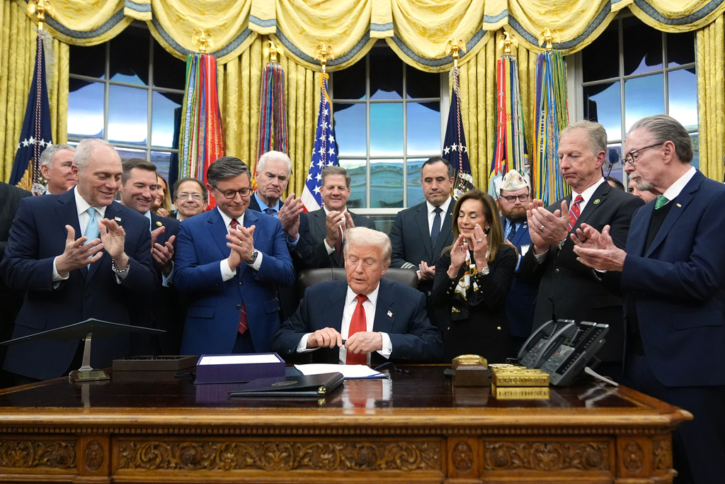 President Donald Trump signs the funding bill to reopen the government, in the Oval Office of the White House, Wednesday, Nov. 12, 2025, in Washington. (AP Photo/Jacquelyn Martin)