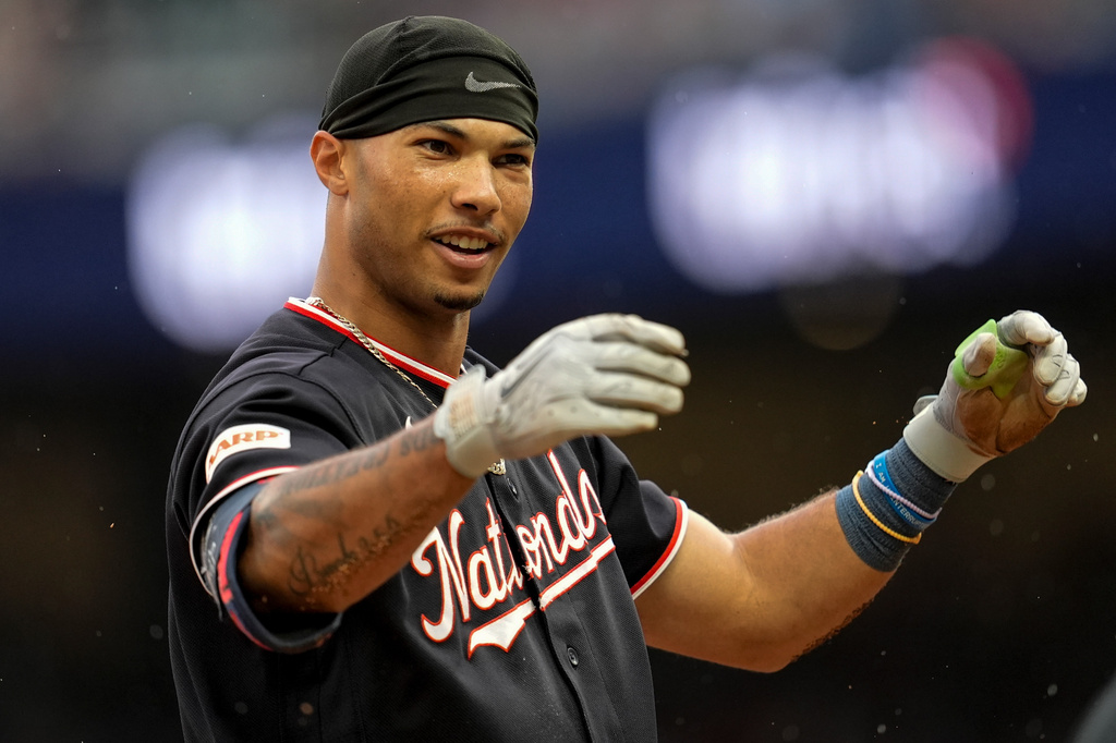Washington Nationals' Daylen Lile reacts to sliding safe to third base after hitting a triple in the second inning of a baseball game against the Atlanta Braves, Saturday, May 23, 2026, in Atlanta. (AP Photo/Mike Stewart)