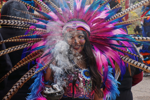 A member of an Aztec dance group holds incense during a commemoration of Día de Muertos (Day of the Dead) at El Colegio High School in Minneapolis on Saturday, Nov. 1, 2025. (AP Photo/Giovanna Dell'Orto) A member of an Aztec dance group holds incense during a commemoration of Día de Muertos (Day of the Dead) at El Colegio High School in Minneapolis on Saturday, Nov. 1, 2025. (AP Photo/Giovanna Dell'Orto)