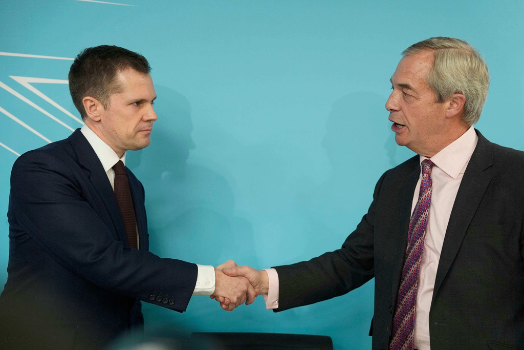 Robert Jenrick with Reform UK leader Nigel Farage at a Reform UK press conference in Westminster, London, where it was announced the former Conservative MP has joined Reform UK, Thursday, Jan. 15, 2026. (Jordan Pettitt/PA via AP)