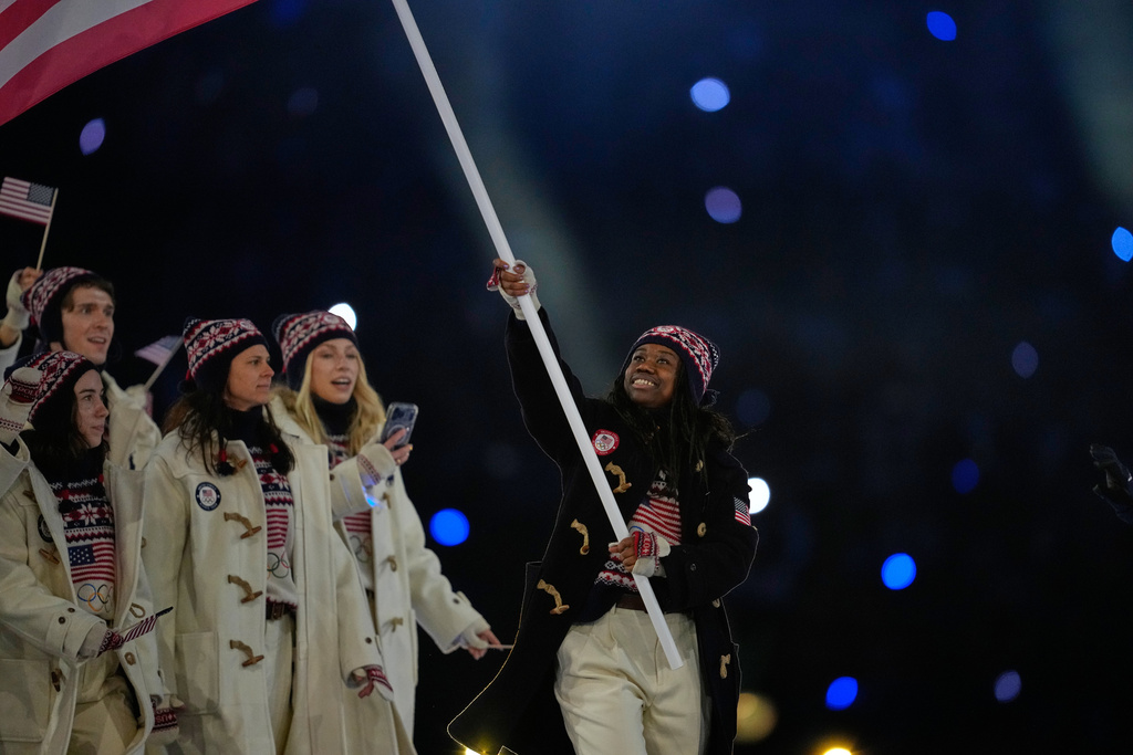 Erin Jackson, flag bearer of United States arrives during the Olympic opening ceremony at the 2026 Winter Olympics, in Milan, Italy, Friday, Feb. 6, 2026. (AP Photo/Ashley Landis)