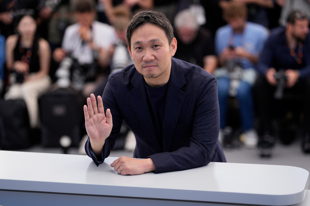 Director Ryûsuke Hamaguchi poses for photographers at the photo call for the film 'All of a Sudden' during the 79th international film festival, Cannes, southern France, Saturday, May 16, 2026. (AP Photo/John Locher)