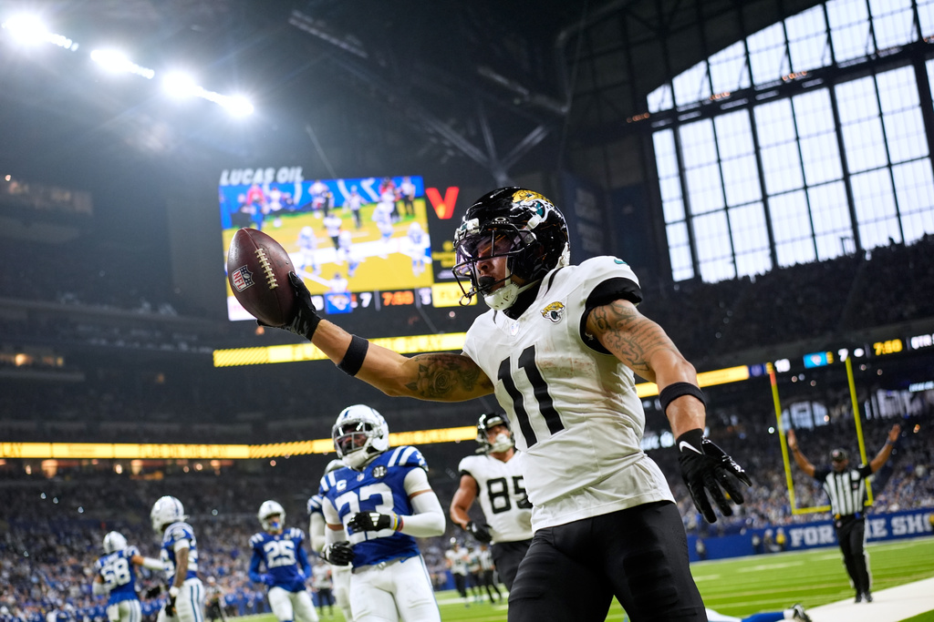 Jacksonville Jaguars wide receiver Parker Washington (11) celebrates after a catch and run during the second half of an NFL football game against the Indianapolis Colts Sunday, Dec. 28, 2025, in Indianapolis. (AP Photo/Carolyn Kaster)
