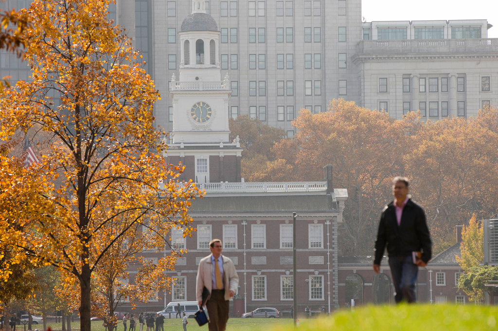 FILE - People walk in view of Independence Hall at the Independence National Historical Park, in Philadelphia, Nov. 12, 2014. (AP Photo/Matt Rourke, File)