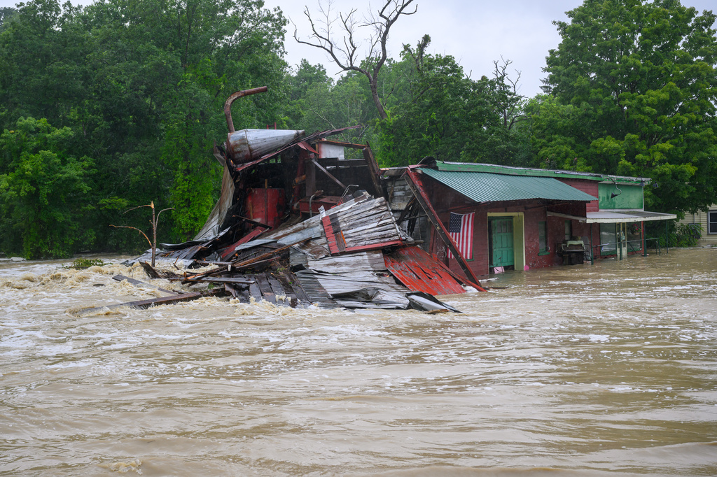A property near the intersection of Route 9J and U.S. Route 1 is battered by floodwaters on Wednesday, July 29, 2026, in Castleton, N.Y., after torrential rainfall triggered widespread flooding across the region. (Jim Franco/The Albany Times Union via AP)