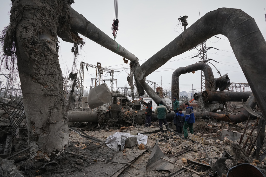 Workers clean up damage at Darnytsia Thermal Power Plant after a Russian attack in Kyiv, Ukraine, Wednesday, Feb. 4, 2026. (AP Photo/Sergei Grits)