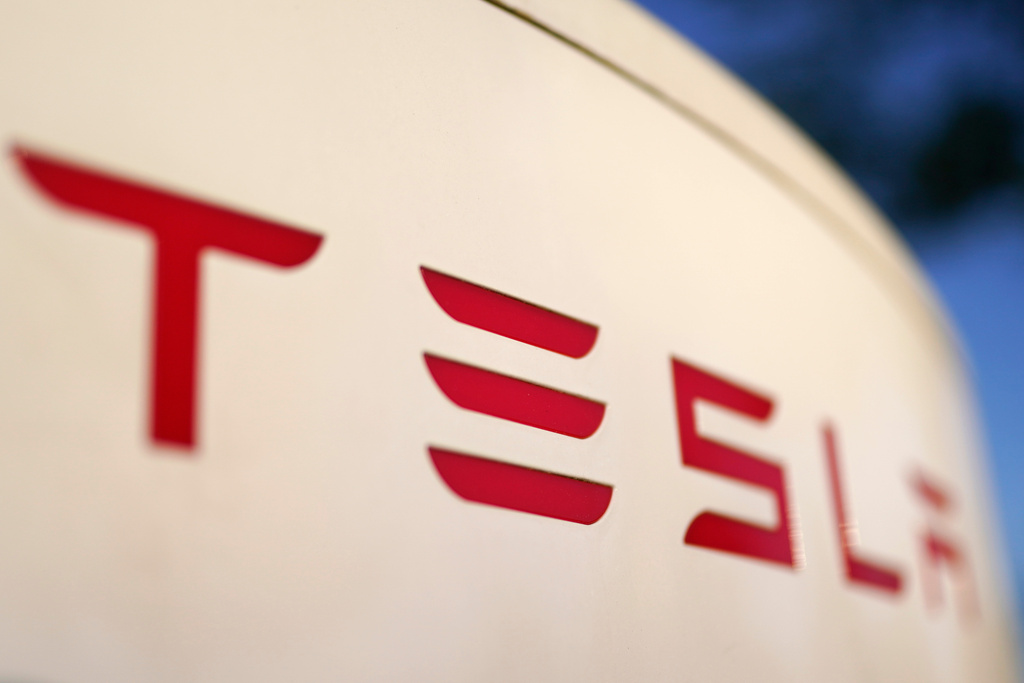 FILE - The logo for the Tesla Supercharger station is seen in Buford, Ga, April 22, 2021. (AP Photo/Chris Carlson, File)