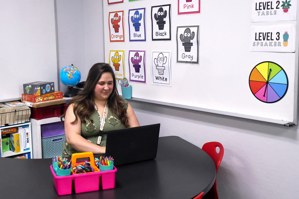 Emily Henderson sits at her desk in her first and second grade classroom ahead of the school year at BASIS Flagstaff on Thursday, Aug. 6, 2026, in Flagstaff, Ariz. (AP Photo/Cheyanne Mumphrey)