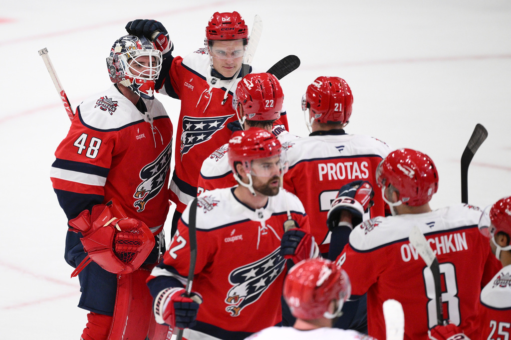 Washington Capitals goaltender Logan Thompson (48) celebrates with teammates after an NHL hockey game against the New York Rangers, Friday, Oct. 9, 2026, in Washington. (AP Photo/Nick Wass)