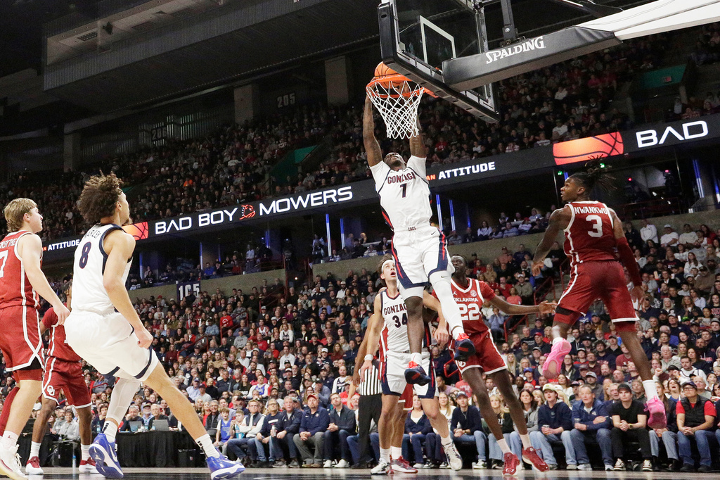 Gonzaga guard Tyon Grant-Foster (7) dunks next to Oklahoma guard Jeff Nwankwo (3) during the first half of an NCAA college basketball game, Saturday, Nov. 8, 2025, in Spokane, Wash. (AP Photo/Young Kwak)
