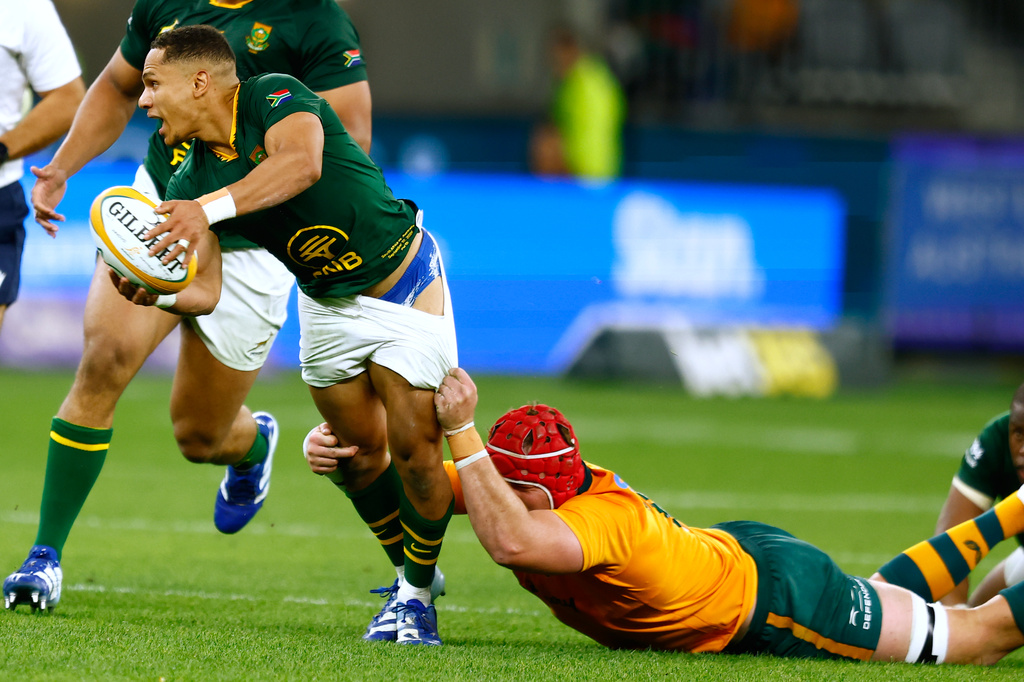 South Africa's Herschel Jantjies, left, is tackled by Australia's Harry Wilson during their rugby union test match in Perth, Australia, on Sunday, Sept. 27, 2026. (AP Photo/Gary Day)