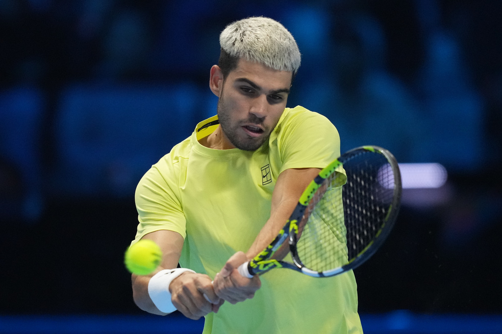 Spain's Carlos Alcaraz returns to Italy's Jannik Sinner during the final tennis match of the ATP World Tour Finals, in Turin, Italy, Sunday, Nov. 16, 2025. (AP Photo/Antonio Calanni)