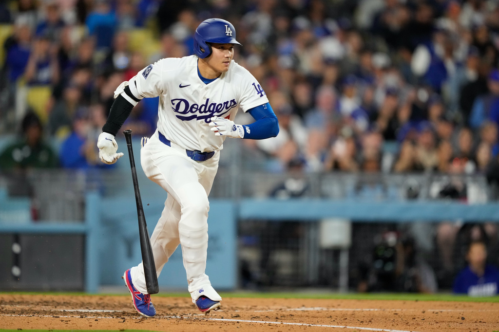Los Angeles Dodgers' Shohei Ohtani heads to first for a single during the fifth inning of a baseball game against the Texas Rangers, Friday, April 10, 2026, in Los Angeles. (AP Photo/Mark J. Terrill)