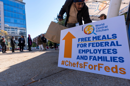 A person gets a bottle of water to go with a meal distributed by chef Jose Andres' World Central Kitchen for federal workers and their families in Canal Park, Monday, Oct. 27, 2025, in Washington. (AP Photo/Alex Brandon) A person gets a bottle of water to go with a meal distributed by chef Jose Andres' World Central Kitchen for federal workers and their families in Canal Park, Monday, Oct. 27, 2025, in Washington. (AP Photo/Alex Brandon)
