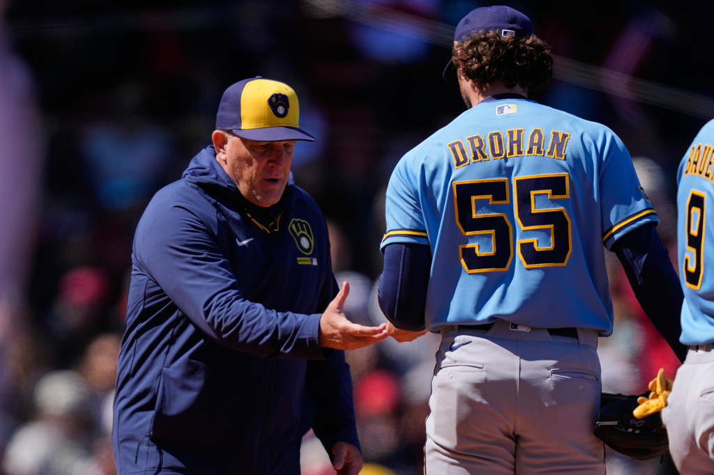 Milwaukee Brewers manager Pat Murphy, left, pulls starting pitcher Shane Drohan (55) during the third inning of a baseball game against the Boston Red Sox at Fenway Park, Wednesday, April 8, 2026, in Boston. (AP Photo/Charles Krupa)