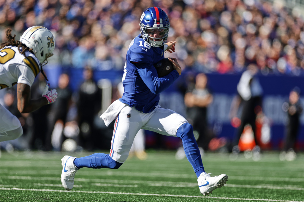 New York Giants quarterback J.J. McCarthy (18) runs the ball during the first half of an NFL football game against the New Orleans Saints in East Rutherford, N.J., Sunday, Oct. 18, 2026. (AP Photo/Adam Hunger)