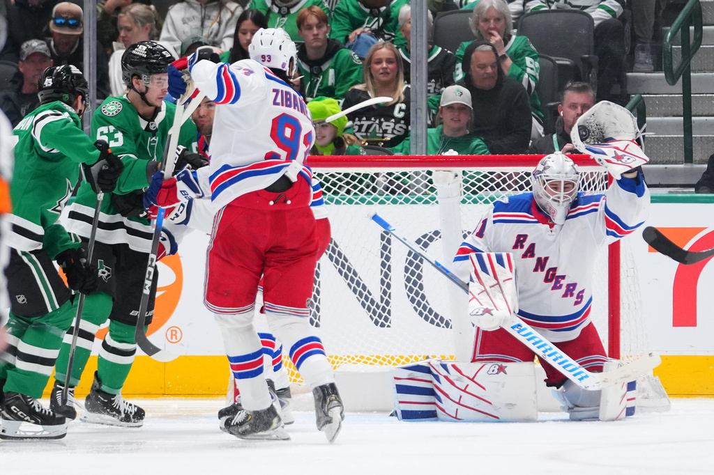 New York Rangers goaltender Igor Shesterkin, right, makes a save against the Dallas Stars during the second period of an NHL hockey game Saturday, April 11, 2026, in Dallas. (AP Photo/Julio Cortez)