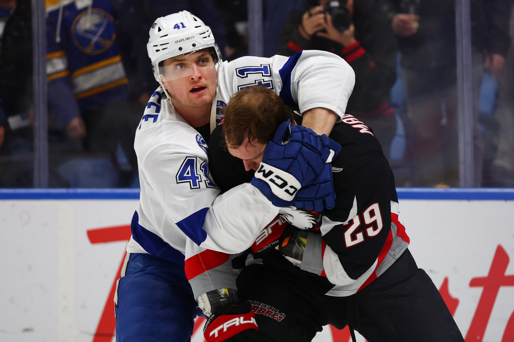 Tampa Bay Lightning right wing Mitchell Chaffee (41) grabs Buffalo Sabres left wing Beck Malenstyn (29) during the first period of an NHL hockey game Monday, April 6, 2026, in Buffalo, N.Y. (AP Photo/Jeffrey T. Barnes)