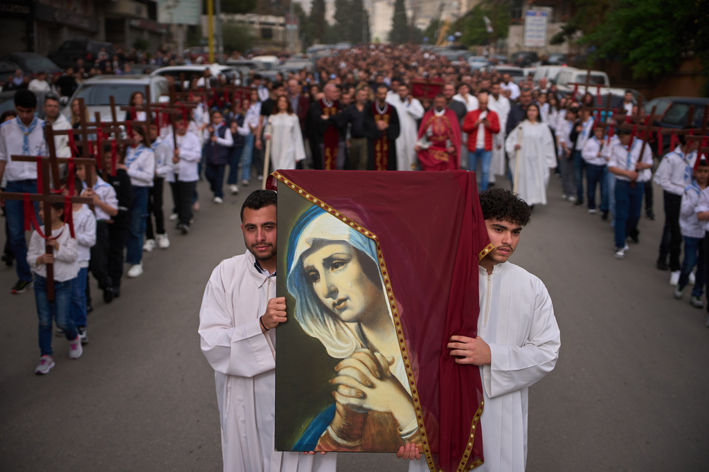 Parishioners walk in a procession after a Good Friday Mass at St. Anthony Church, which was devoted to expressing solidarity with Christian villagers in southern Lebanon displaced by the war in Jdeideh, a suburb of Beirut, Lebanon, Friday, April 3, 2026. (AP Photo/Emilio Morenatti)
