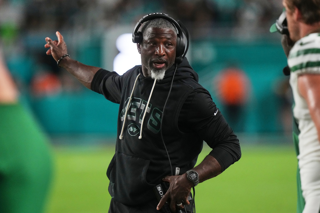 New York Jets head coach Aaron Glenn instructs staff as he watches play against the Miami Dolphins in the first half of an NFL football game, Monday, Sept. 29, 2025, in Miami Gardens, Fla. (AP Photo/Marta Lavandier)