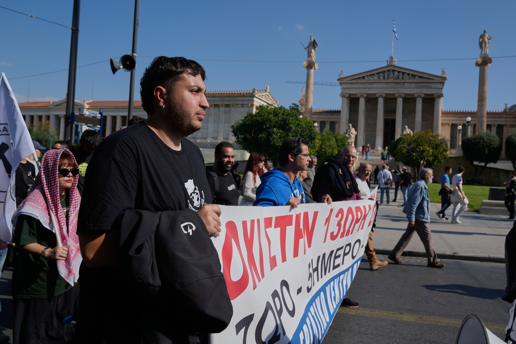 Protesters take part in a nationwide 24-hour strike in Athens, Greece, Tuesday, Oct. 14, 2025, as labor unions demand higher wages and the withdrawal of a bill changing work hours. (AP Photo/Petros Giannakouris)