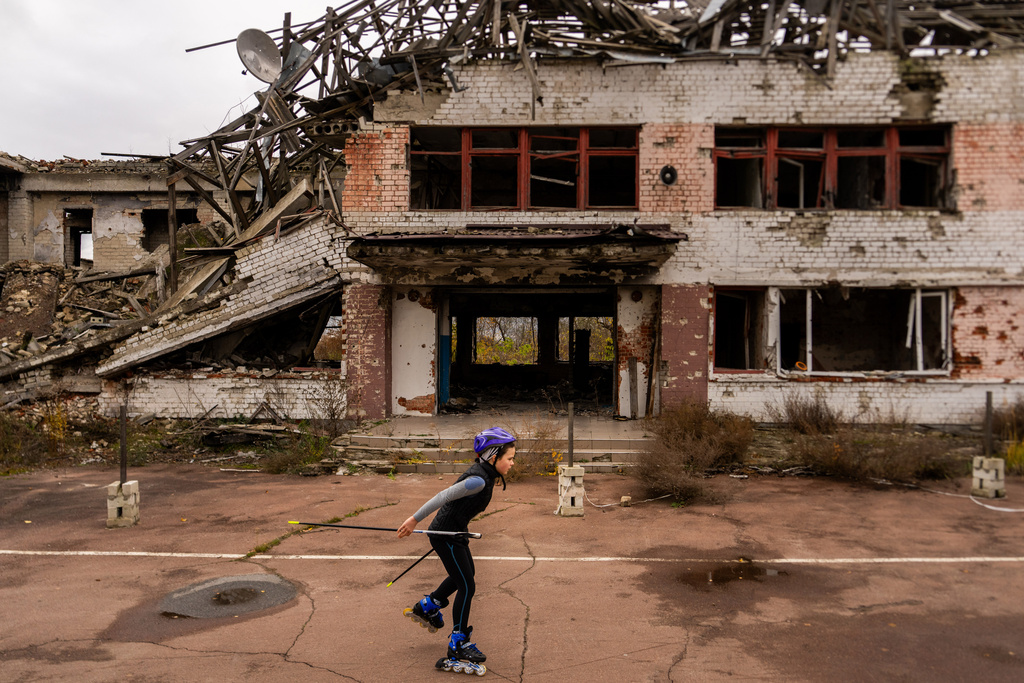 A young biathlete trains outside the destroyed ski base in Chernihiv, Ukraine, Thursday, Oct. 30, 2025. (AP Photo/Julia Demaree Nikhinson)