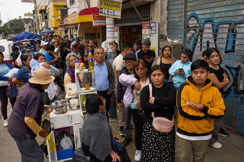 People line up to collect their national identity cards ahead of Peru's presidential runoff election in Lima, Peru, Saturday, June 6, 2026. (AP Photo/Rodrigo Abd)