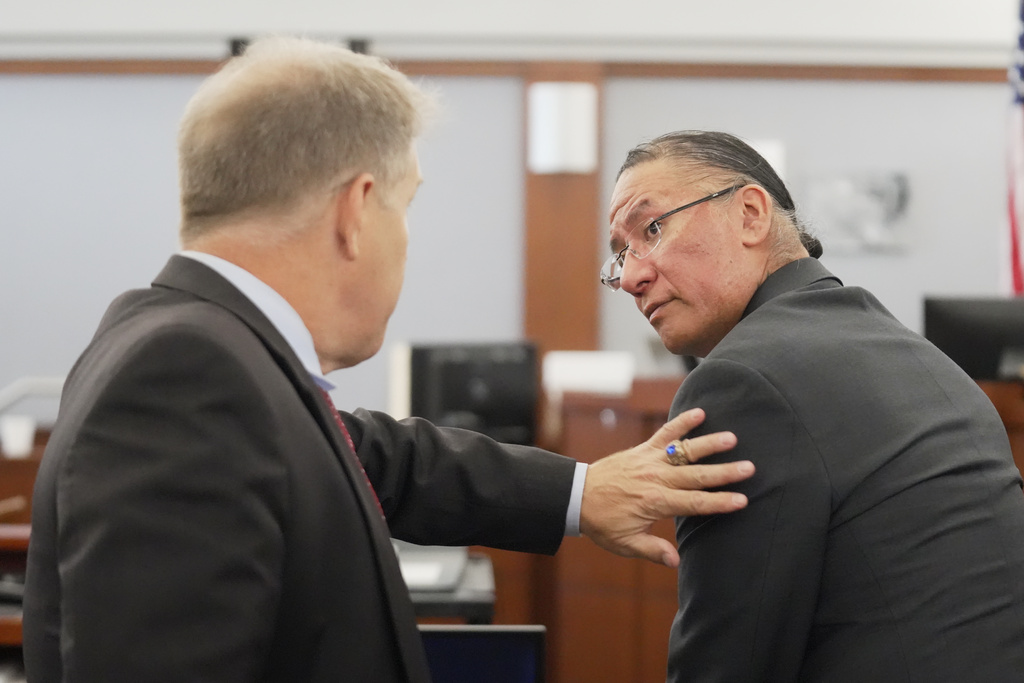 Nathan Chasing Horse, right, talks to his attorney Craig Mueller during his trial on charges of sexually abusing Indigenous women and girls Tuesday, Jan. 13, 2026, in Las Vegas. (AP Photo/Ty ONeil)