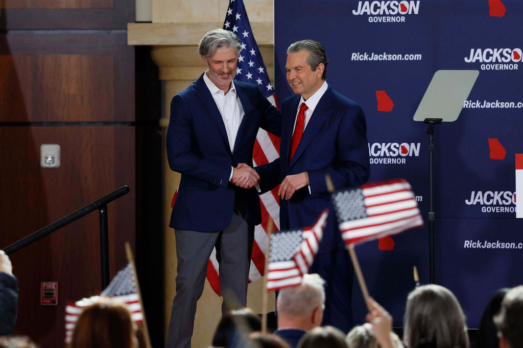 Shane Jackson shakes hands with his father, Rick Jackson, a healthcare business owner, after his campaign kickoff speech for Georgia governor at Jackson Healthcare, in Alpharetta, Ga., Wednesday, Feb. 4, 2026. (Miguel Martinez/Atlanta Journal-Constitution via AP)