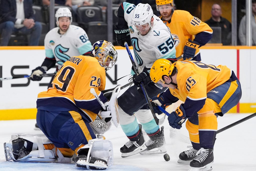 Nashville Predators goaltender Justus Annunen (29) and defenseman Ryan Ufko (85) defend the goal against Seattle Kraken defenseman Ryan Lindgren (55) during the third period of an NHL hockey game Thursday, March 19, 2026, in Nashville, Tenn. (AP Photo/George Walker IV)