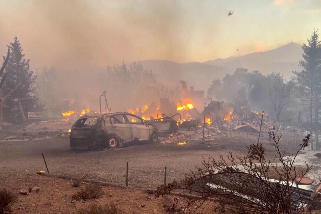 This image taken from video shows a charred neighborhood following wildfires Saturday, Aug. 22, 2026, in Reno, Nevada. (Tim Walton via AP)