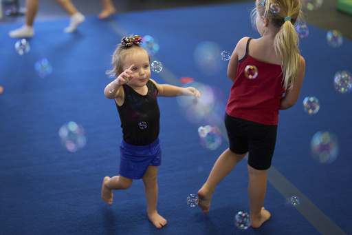 Brooklyn Marris, left, chases bubbles at the end of a gymnastics class in Winchester, Calif., on Thursday, Sept. 18, 2025. (AP Photo/Gregory Bull) Brooklyn Marris, left, chases bubbles at the end of a gymnastics class in Winchester, Calif., on Thursday, Sept. 18, 2025. (AP Photo/Gregory Bull)