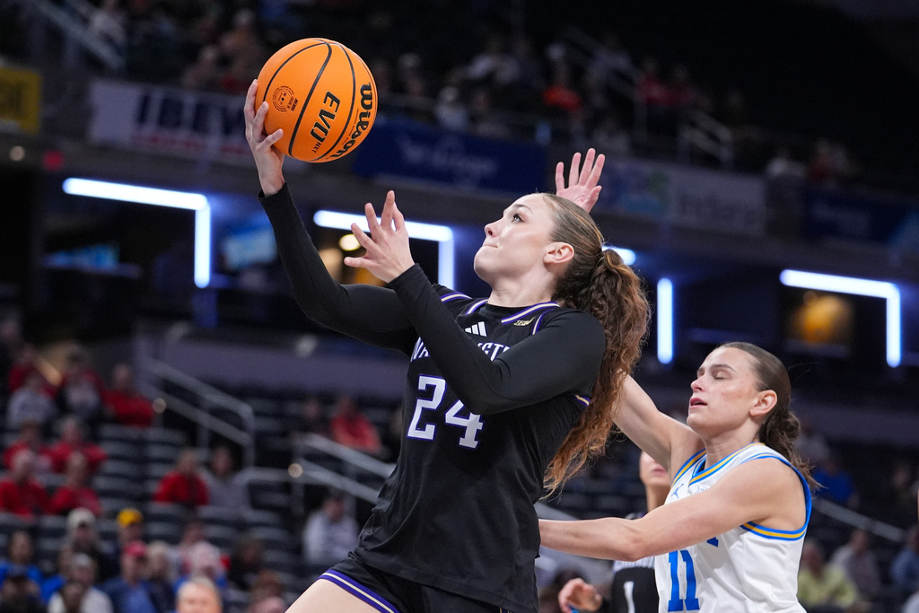 Washington guard Elle Ladine (24) shoots in front of UCLA forward Gabriela Jaquez (11) in the first half of an NCAA college basketball game in the quarterfinals of the Big Ten Conference tournament, Friday, March 6, 2026 in Indianapolis. (AP Photo/Michael Conroy)