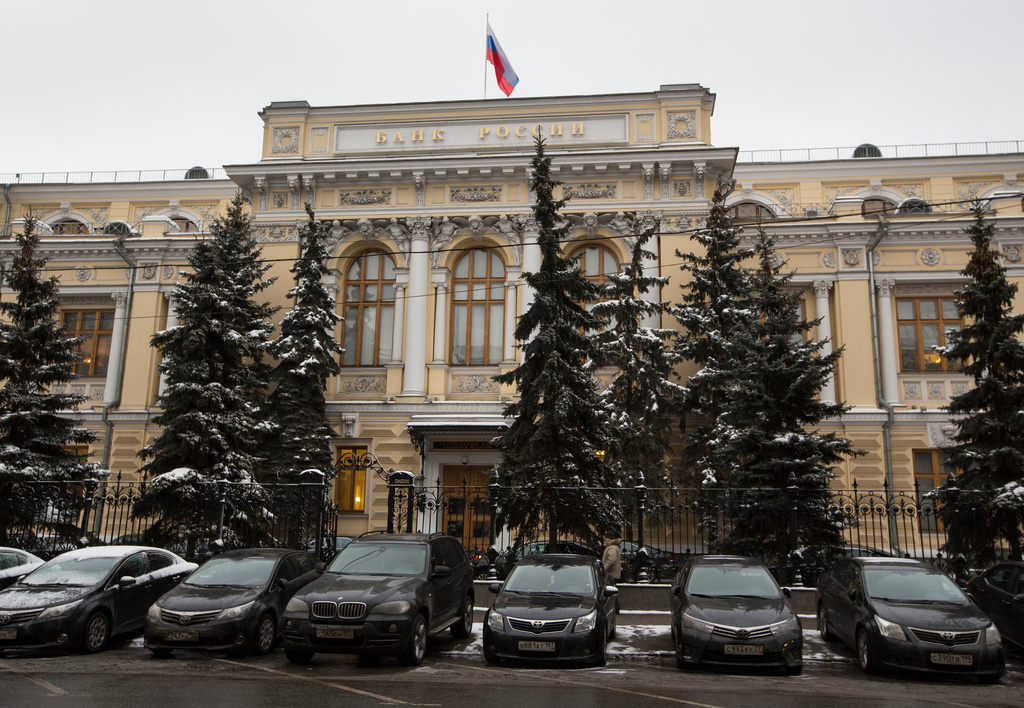 FILE - Cars are parked in front of Russia's Central Bank building in Moscow, Russia, Friday, Jan. 30, 2015. (AP Photo/Alexander Zemlianichenko, File)