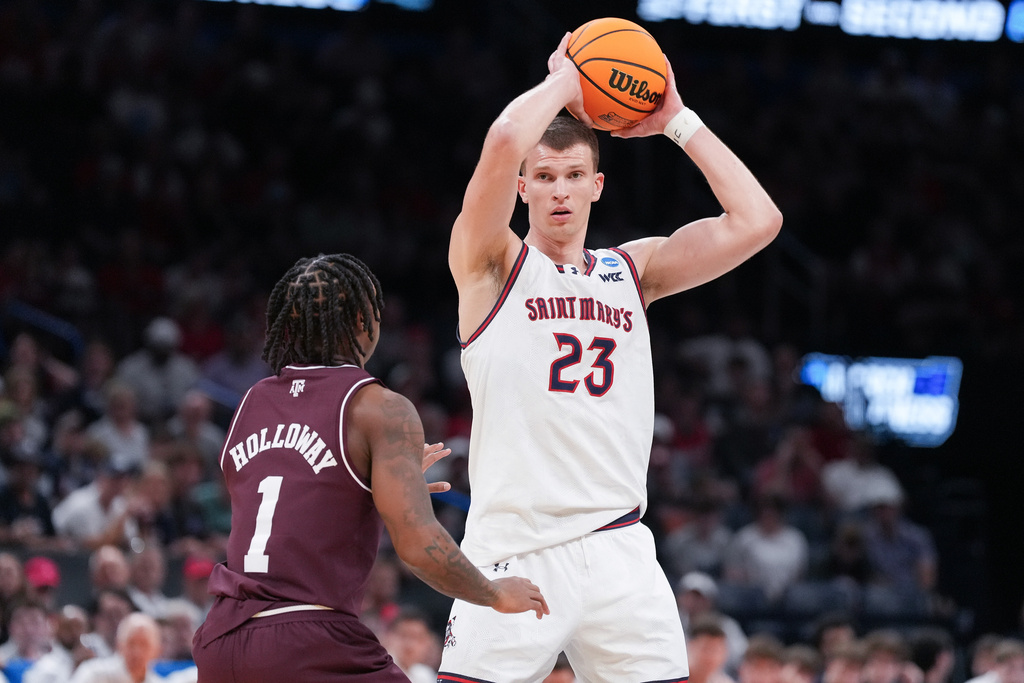 FILE - Saint Mary's forward Paulius Murauskas (23) keeps the ball away from Texas A&M guard Josh Holloway (1) during the first half in the first round of the NCAA college basketball tournament, March 19, 2026, in Oklahoma City. (AP Photo/Kyle Phillips, File)
