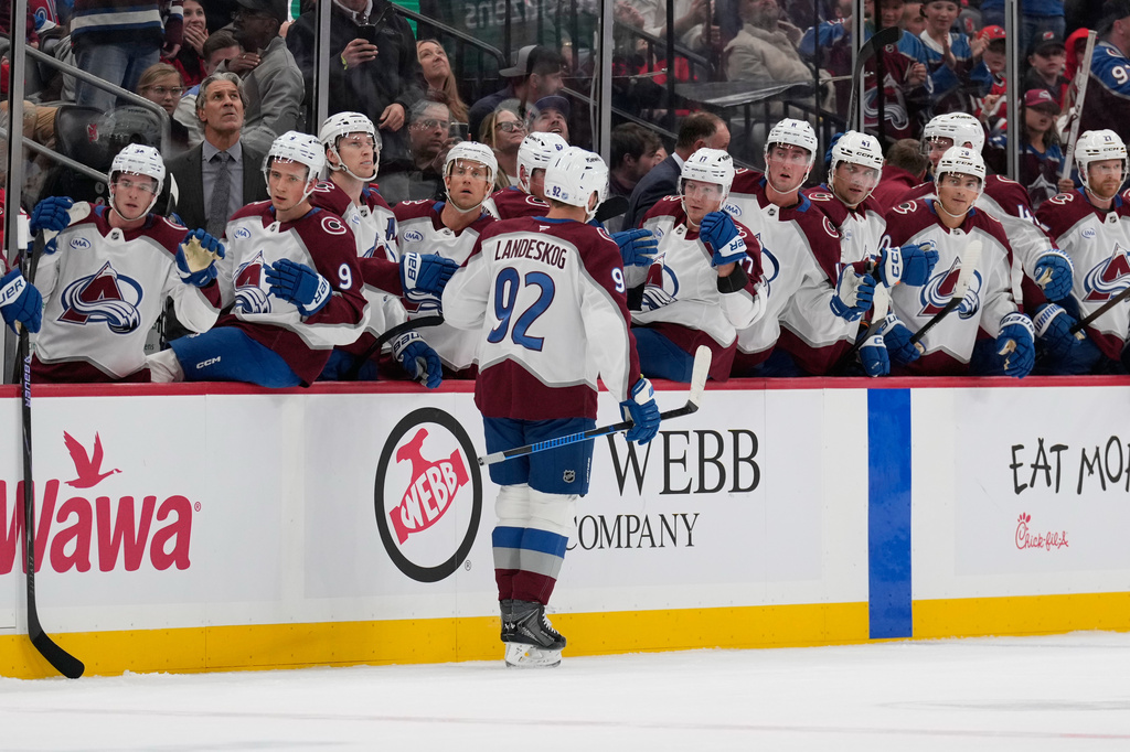 Teammates celebrate with Colorado Avalanche's Gabriel Landeskog after his goal during the first period of an NHL hockey game against the New Jersey Devils in Newark, N.J., Tuesday, Oct. 20, 2026. (AP Photo/Seth Wenig)