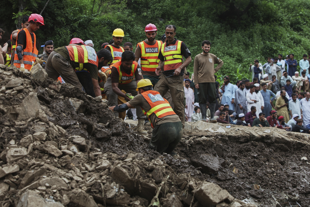 Rescue workers search victims through the rubble of damaged homes following Monday's flash flooding due to heavy rains, in Dalori village in Swabi, a district of Pakistan's Khyber Pakhtunkhwa province, Tuesday, Aug. 19, 2025. (AP Photo/Muhammad Zubair)