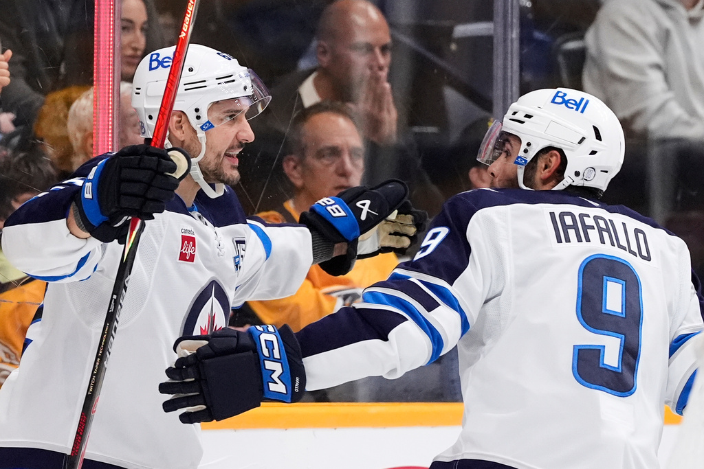 Winnipeg Jets right wing Nino Niederreiter, left, celebrates his goal with left wing Alex Iafallo (9) during the first period of an NHL hockey game against the Nashville Predators, Saturday, Nov. 29, 2025, in Nashville, Tenn. (AP Photo/George Walker IV)