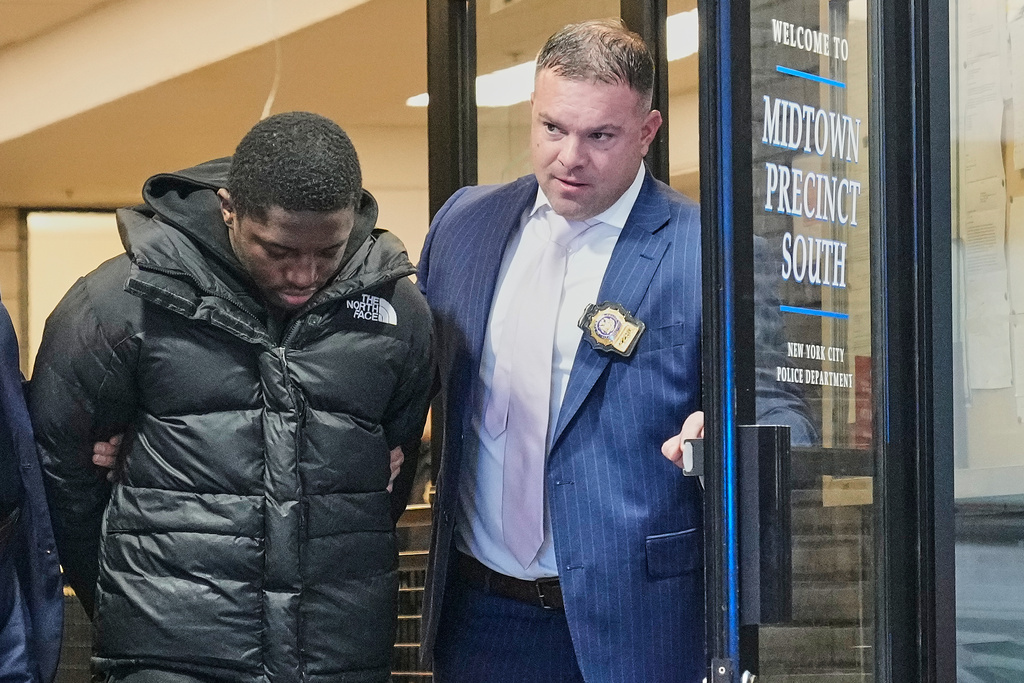 Frederick Green, 20, of The Bronx borough of New York, charged with attempted murder in the shooting of New York Jets' player Kris Boyd, is escorted from the Midtown South Police Precinct, in New York, Tuesday, Dec. 9, 2025. (AP Photo/Richard Drew)