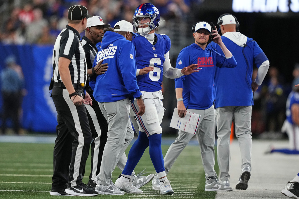 New York Giants quarterback Jaxson Dart (6) is walked off the field after being tackled by the New England Patriots during the first quarter of an NFL football game, Thursday, Aug. 21, 2025, in East Rutherford, N.J. (AP Photo/Yuki Iwamura)