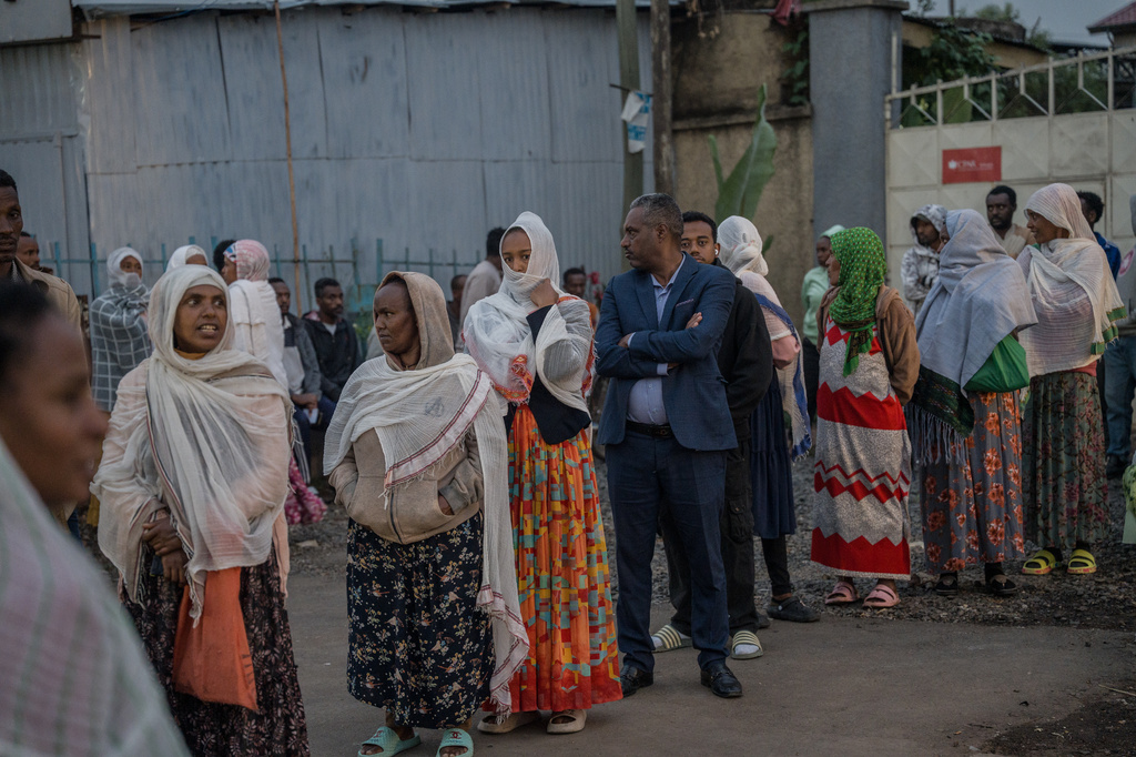 People gather outside a polling station before casting their votes in the general election in Addis Ababa, Ethiopia, Monday, June 1, 2026. (AP Photo/Amanuel Sileshi)