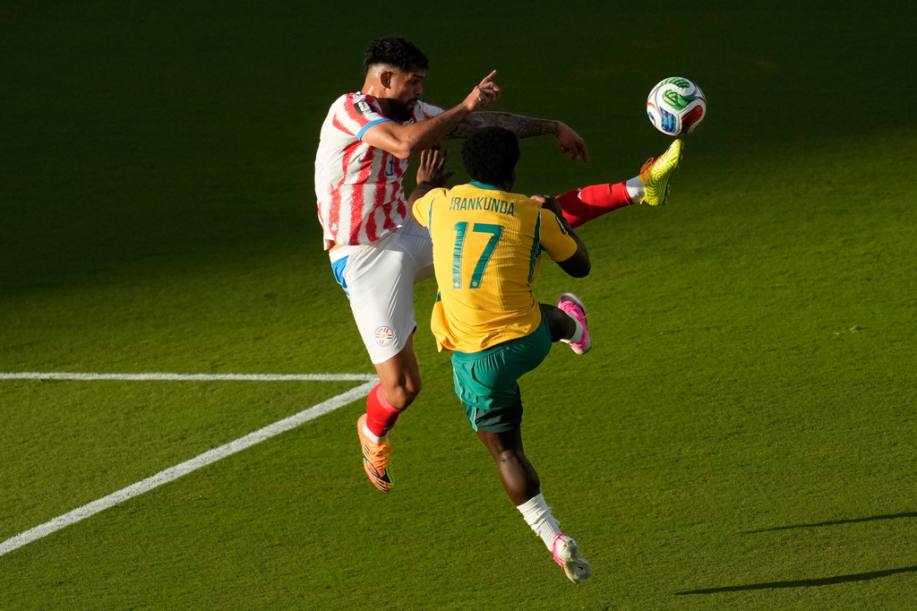 Paraguay's Omar Alderete (3) kicks the ball over Australia's Nestory Irankunda (17) during the World Cup Group D soccer match between Paraguay and Australia in Santa Clara, Calif., near San Francisco, Thursday, June 25, 2026. (AP Photo/Jeff Chiu)