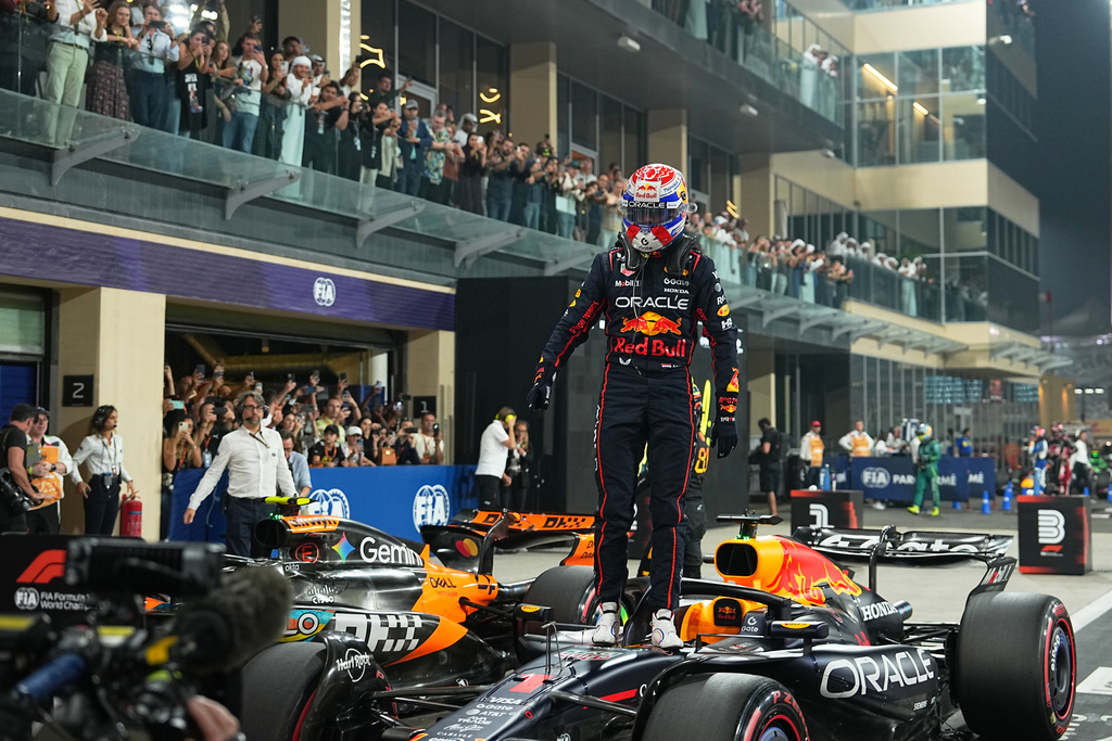 Red Bull driver Max Verstappen of the Netherlands celebrates after clocked the fastest time during the qualifying session ahead of the Formula One Abu Dhabi Grand Prix at the Yas Marina Circuit in Abu Dhabi, UAE, Saturday, Dec. 6, 2025. (AP Photo/Fatima Shbair)