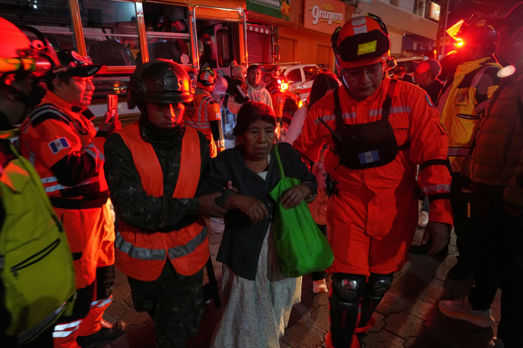 Families evacuated from areas surrounding the Fuego Volcano arrive at a temporary shelter in San Juan Alotenango, Guatemala, Tuesday, Aug. 4, 2026. (AP Photo/Moises Castillo)