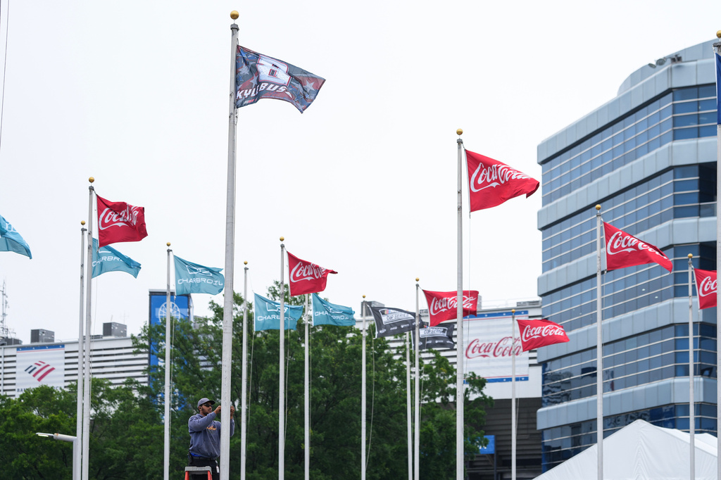 A flag is raised in honor of the late driver Kyle Busch outside of Charlotte Motor Speedway, Friday, May 22, 2026, in Charlotte, N.C. (AP Photo/Matt Kelley)