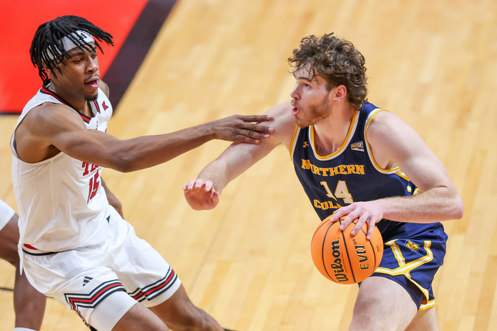 Northern Colorado forward Brock Wisne (14) drives to the hoop around Texas Tech forward JT Toppin (15) during the second half of an NCAA college basketball game, Tuesday, Dec. 16, 2025, in Lubbock, Texas. (AP Photo/Chase Seabolt)