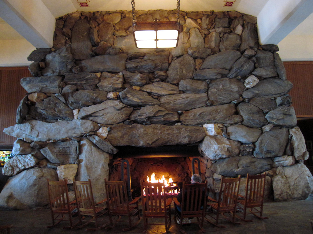 FILE - This Feb. 2, 2015 photo shows rocking chairs in front of the massive stone fireplace in the lobby of the Grove Park Inn in Asheville, N.C. (AP Photo/Beth J. Harpaz, File)