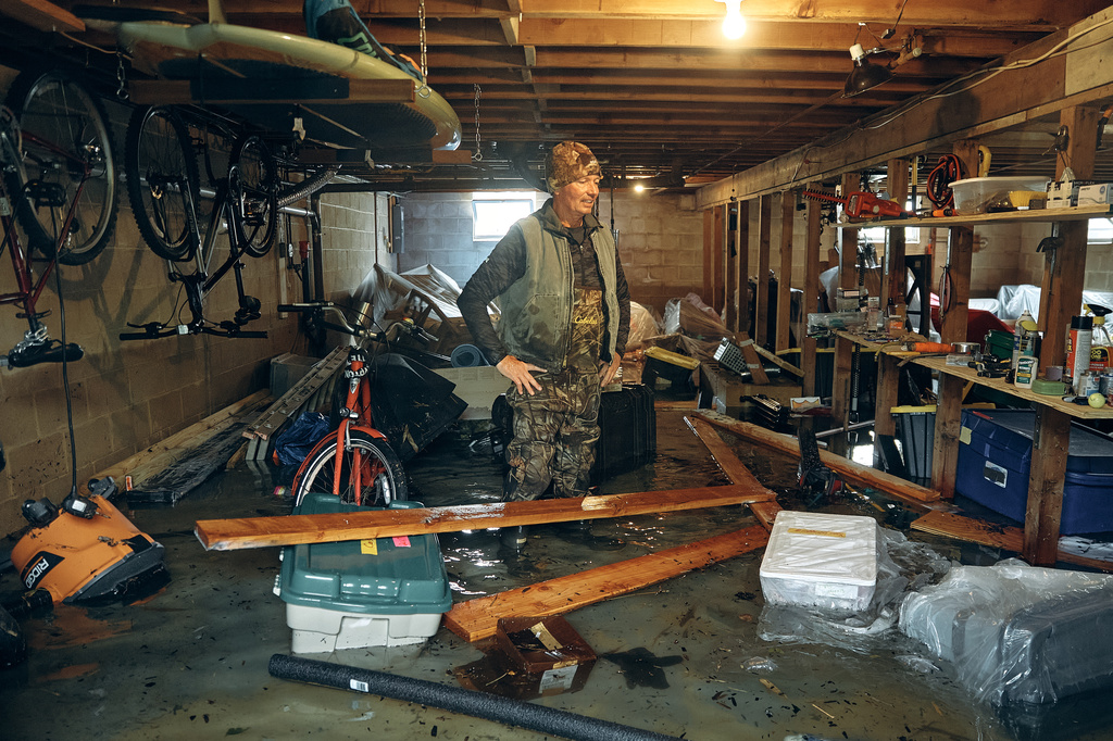 Bernard Dowd checks his flooded basement during a nor'easter storm on Sunday, Sept. 27, 2026, in Sea Bright, N.J. (AP Photo/Andres Kudacki)