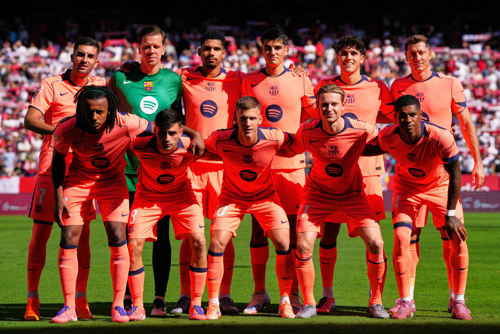 Barcelona starting players pose for a team photo at the beginning of the Spanish La Liga soccer match between Sevilla and Barcelona at the Ramon Sanchez Pizjuan stadium in Seville, Spain, Sunday, Oct. 5, 2025. (AP Photo/Jose Breton)