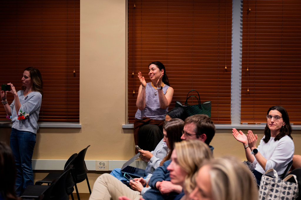 Attendees clap during a school board meeting at the Lower Merion School District Administration Building on Monday, May 11, 2026, in Ardmore, Pa. (AP Photo/Joe Lamberti)